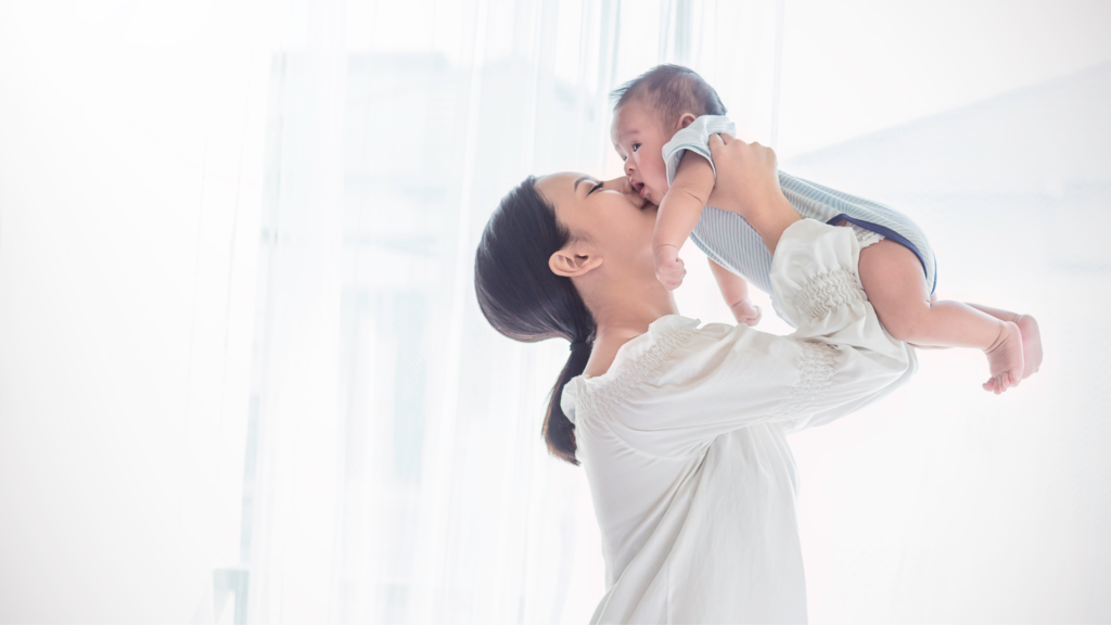 asian mother carrying baby 