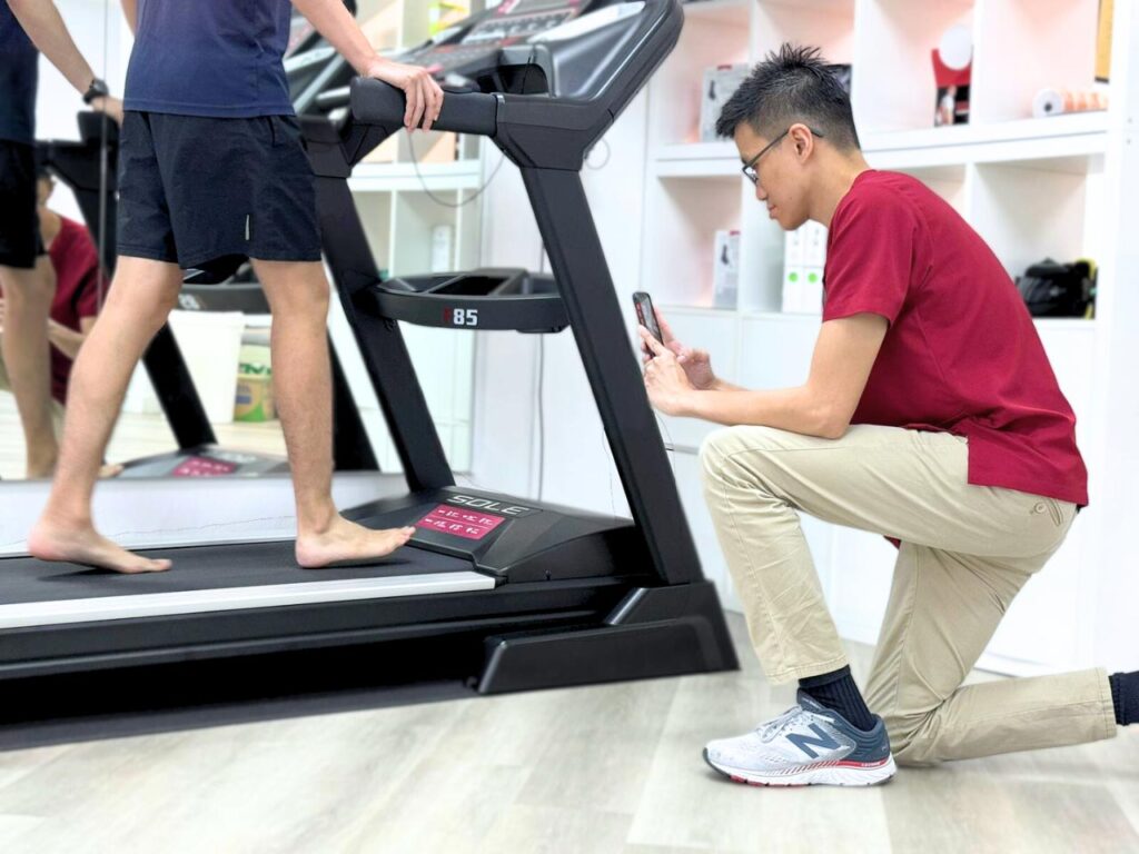Adult undergoing gait analysis on a treadmill at Physio and Sole Clinic, guided by a expert podiatrist for foot health and mobility improvement.