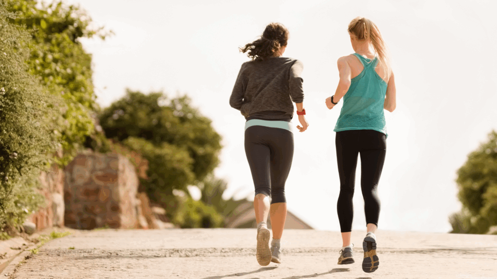 2 lady athletes running together 