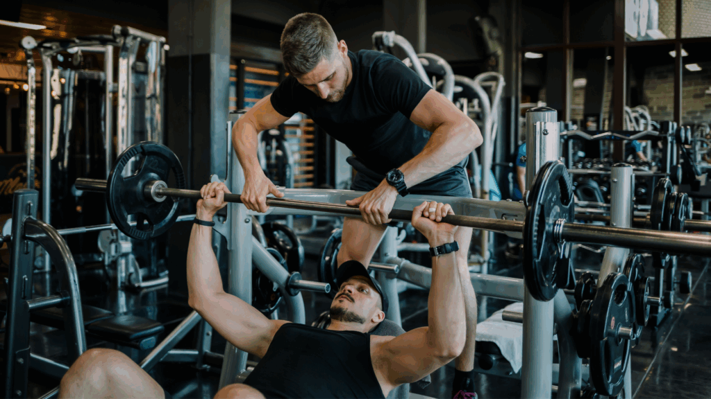 Sports Physio assisting weight lifter and athlete Boost Performance while lifting weights
