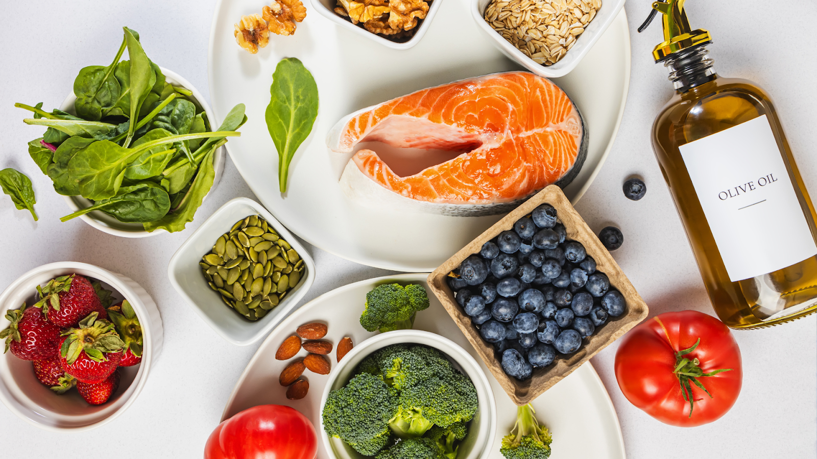 Anti-inflammatory foods like salmon, olive oil, and berries that help manage rheumatoid arthritis