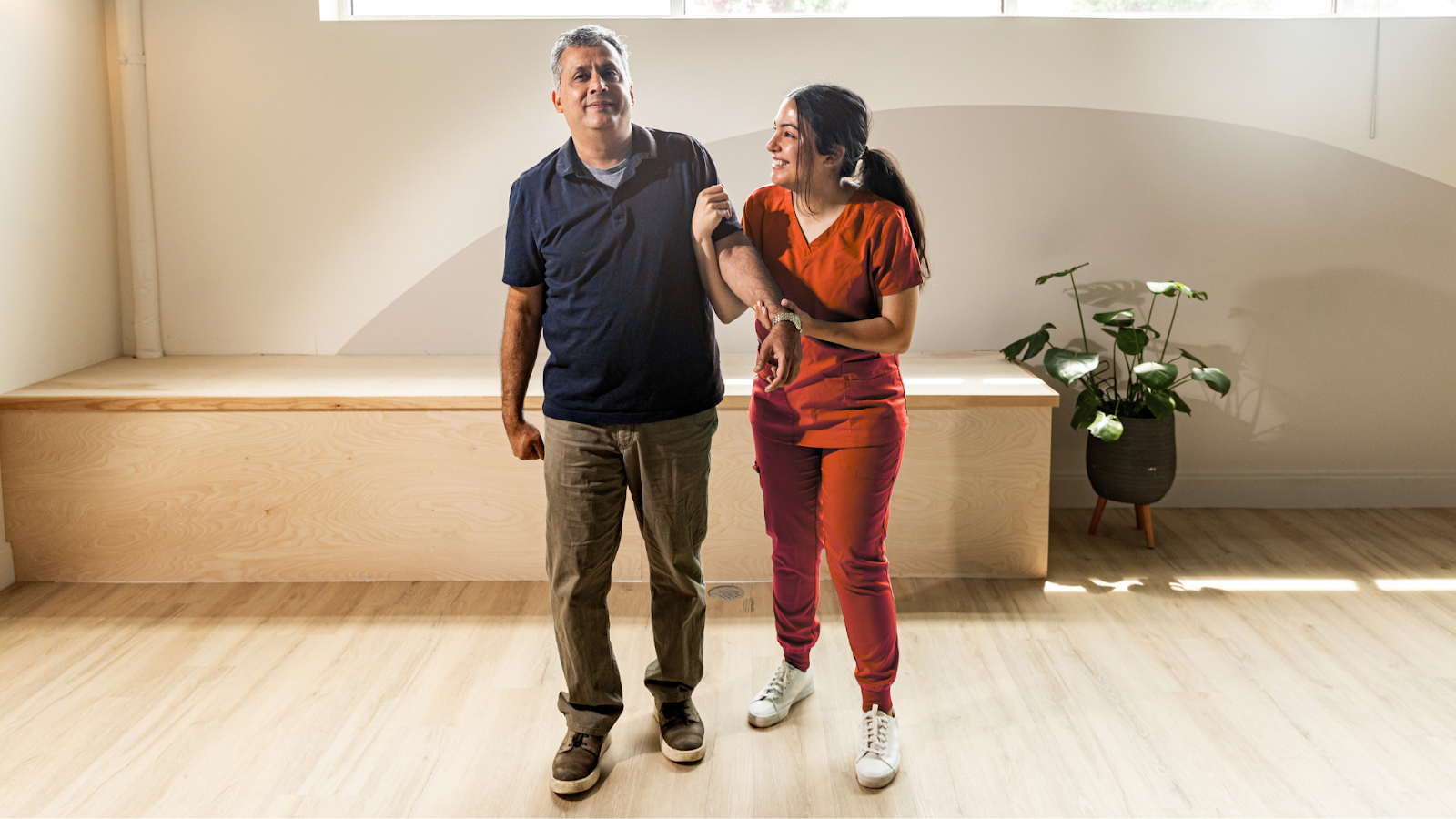 Middle-aged man undergoing physiotherapy to maintain mobility after rheumatoid arthritis diagnosis