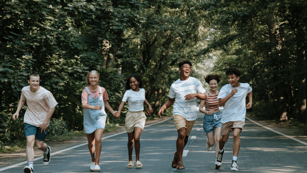 Group of diverse teenagers running outdoors, staying active