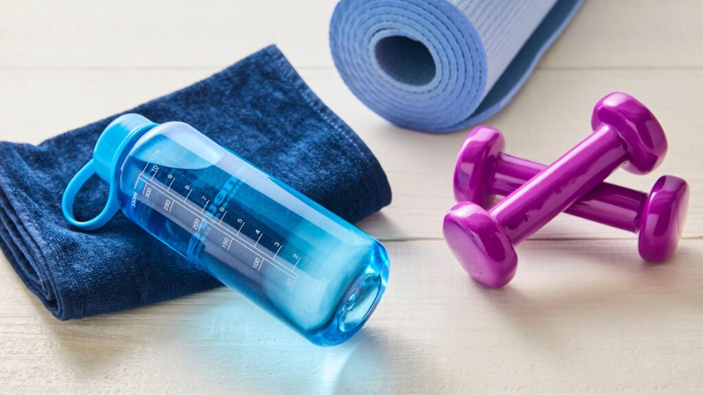 water tumbler, dumbbells and towels 