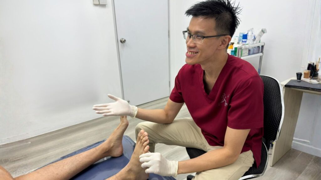 foot doctor in singapore taking care of a patient
