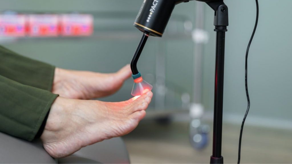 Photodynamic antimicrobial therapy being applied to toenails as an advanced nail fungus treatment.
