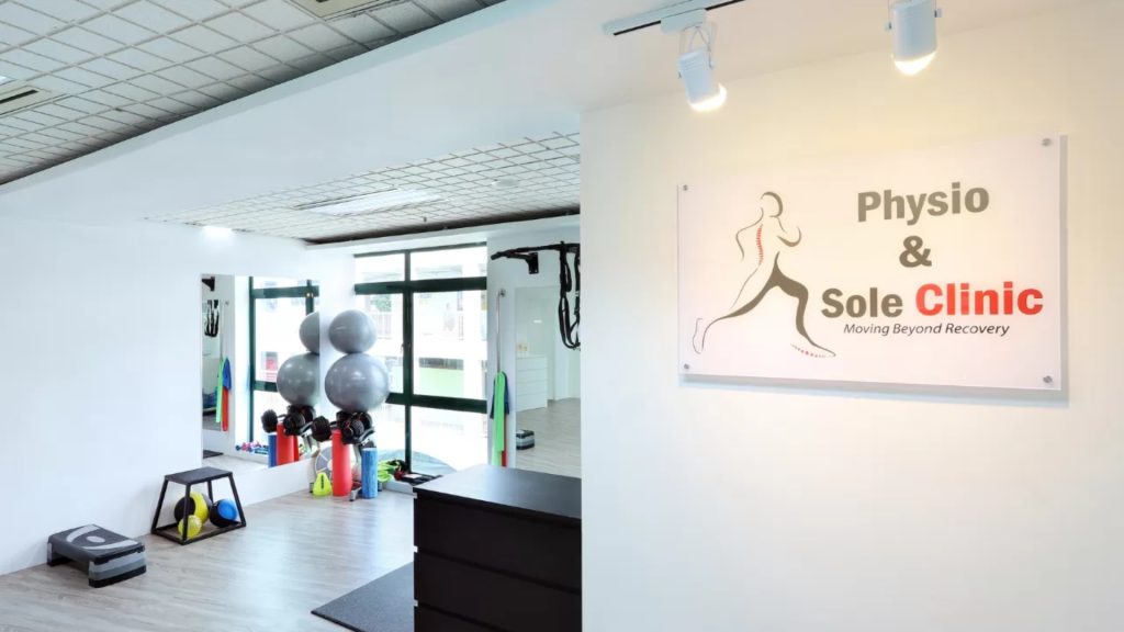 Interior of Physio & Sole Clinic showing treatment area and clinic signage.