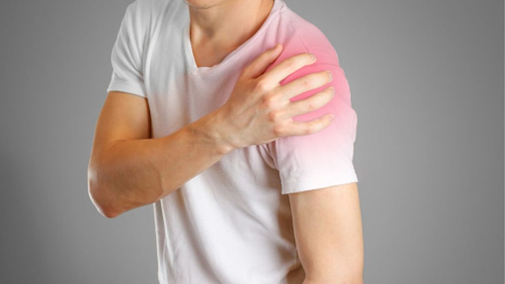 Person experiencing shoulder tendon pain, highlighting persistent discomfort despite previous treatment