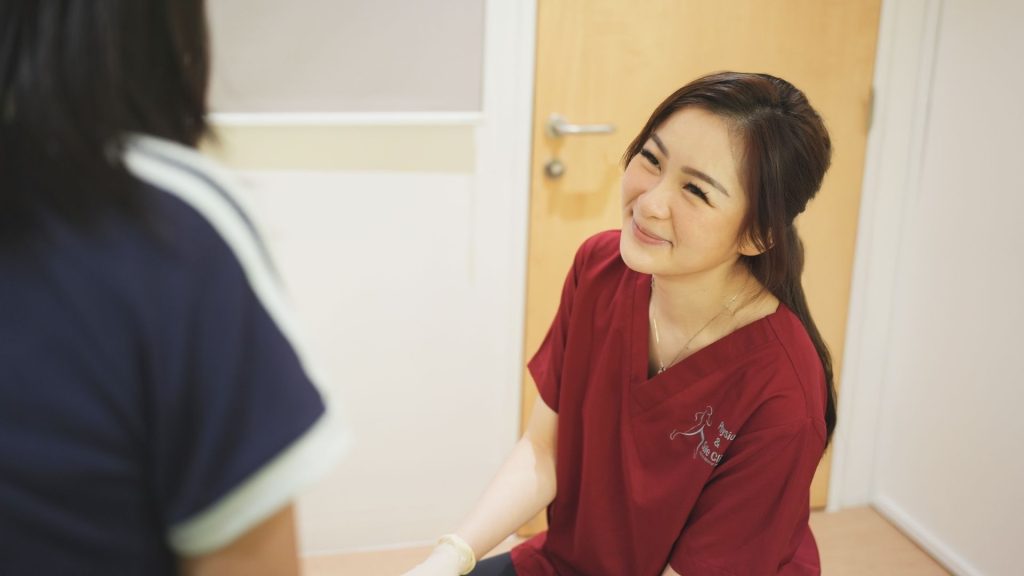 Podiatrist discussing the cause of foot pain after running and treatment options with a runner in clinic