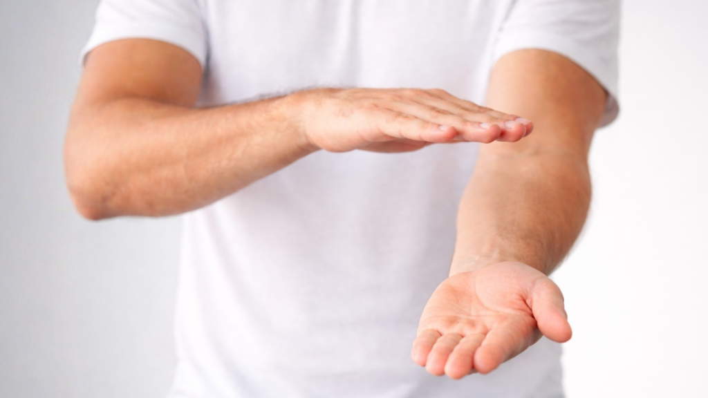 Forearm rotation exercise showing the hand turning between palm-up and palm-down positions