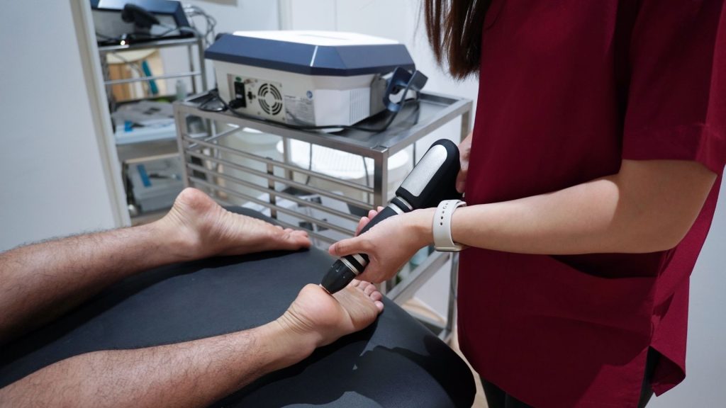 Physiotherapy clinician in Singapore consulting patients on treatment and rehabilitation for injury recovery