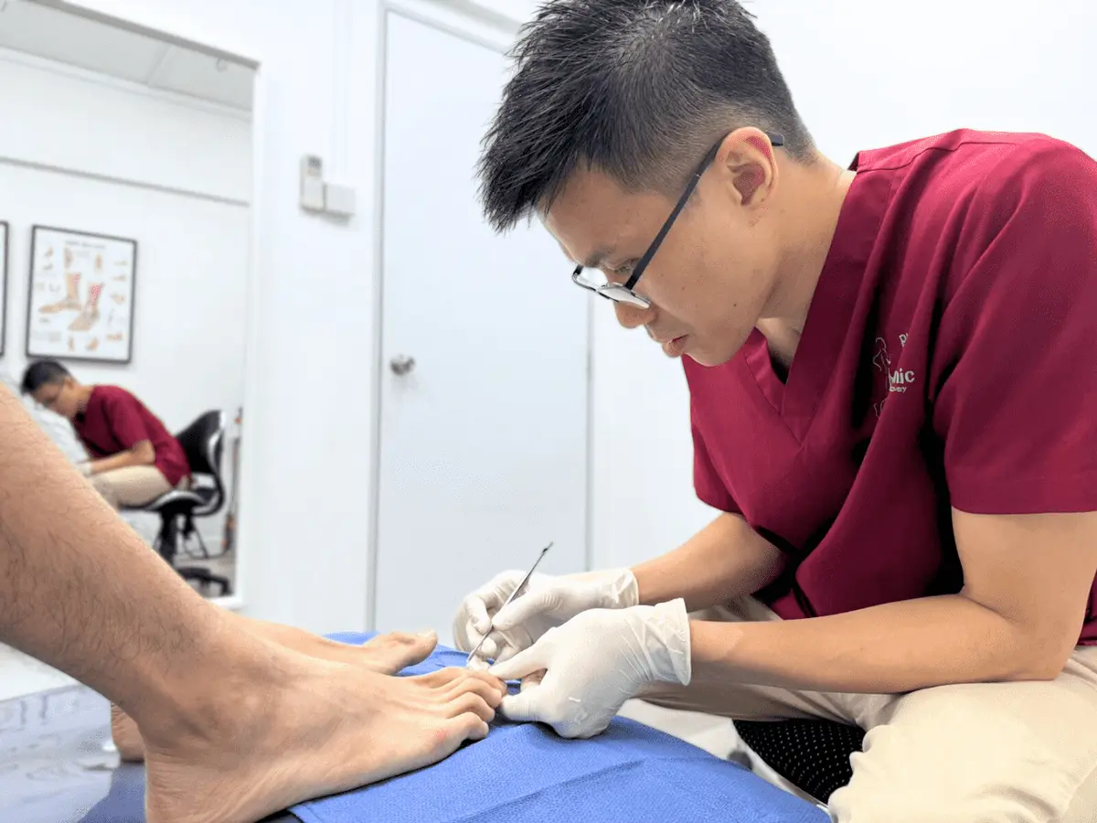 A podiatrist treating a patient