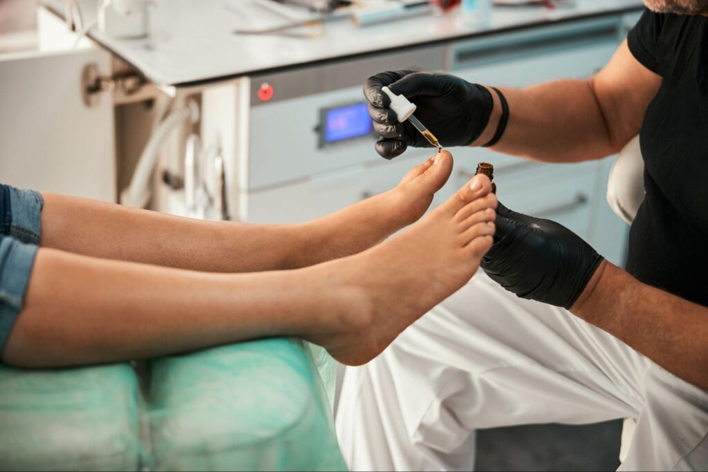 podiatrist putting on on toenail