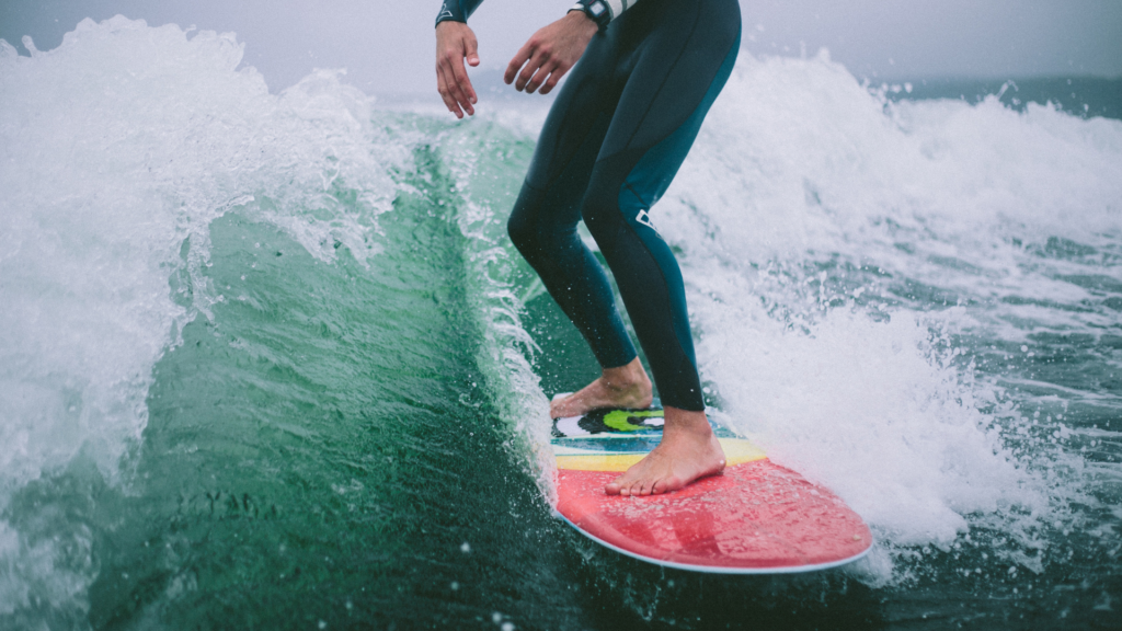 A person on a surfboard is surfing in the waves