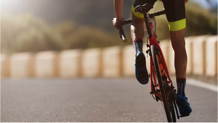 a person riding on a red bicycle
