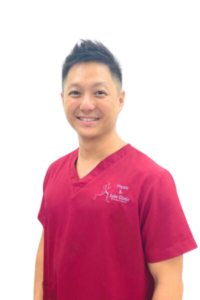 Physio and Sole Clinic Principal Podiatrist Siew Keong (SK) in red scrubs