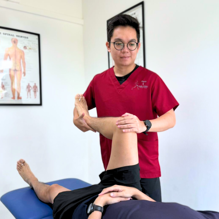 Physiotherapist adjusting patient leg