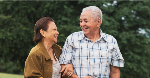 Smiling elderly couple enjoying a stroll, highlighting the importance of maintaining foot health and wellness through services like medical pedicures.
