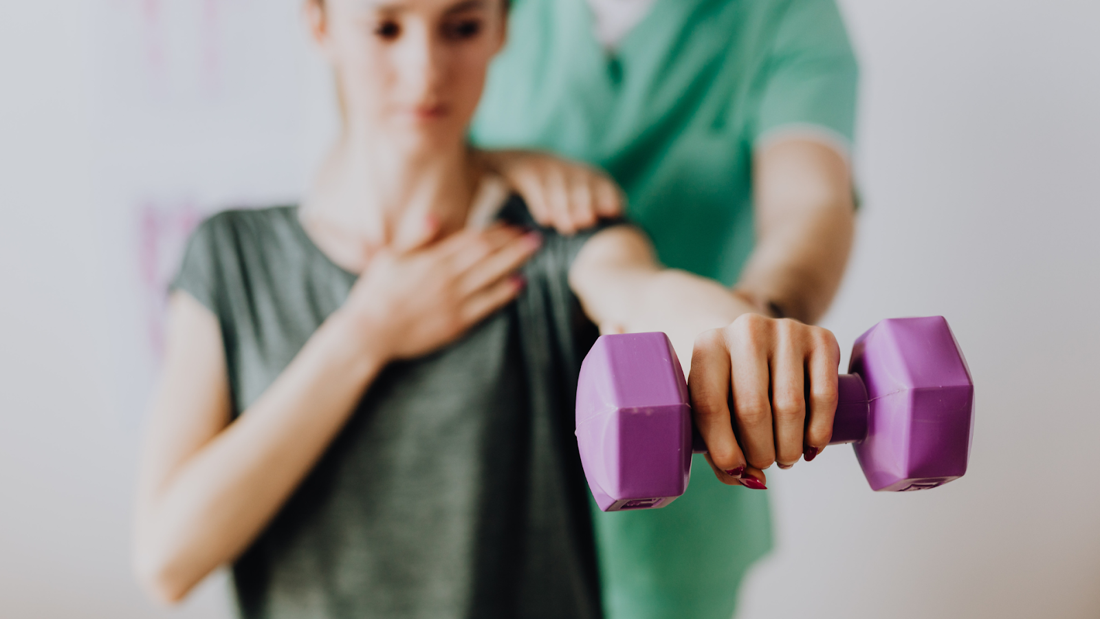 A physiotherapist assisting a patient with targeted strength training for scoliosis as part of Schroth Therapy.