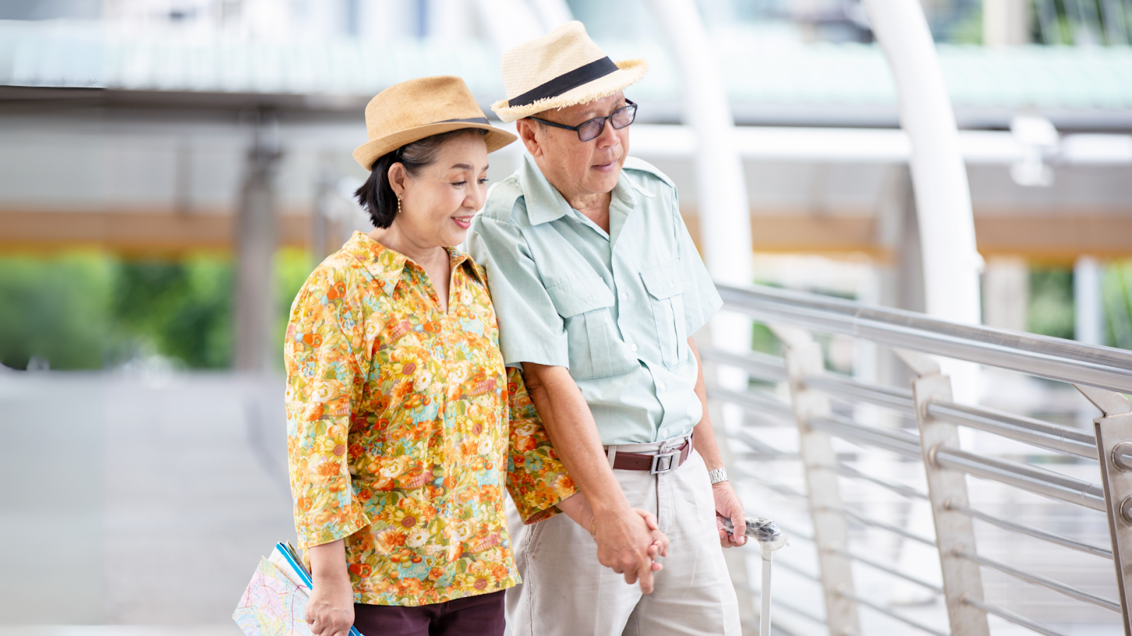 Elderly couple walking hand-in-hand, staying active despite foot pain concerns