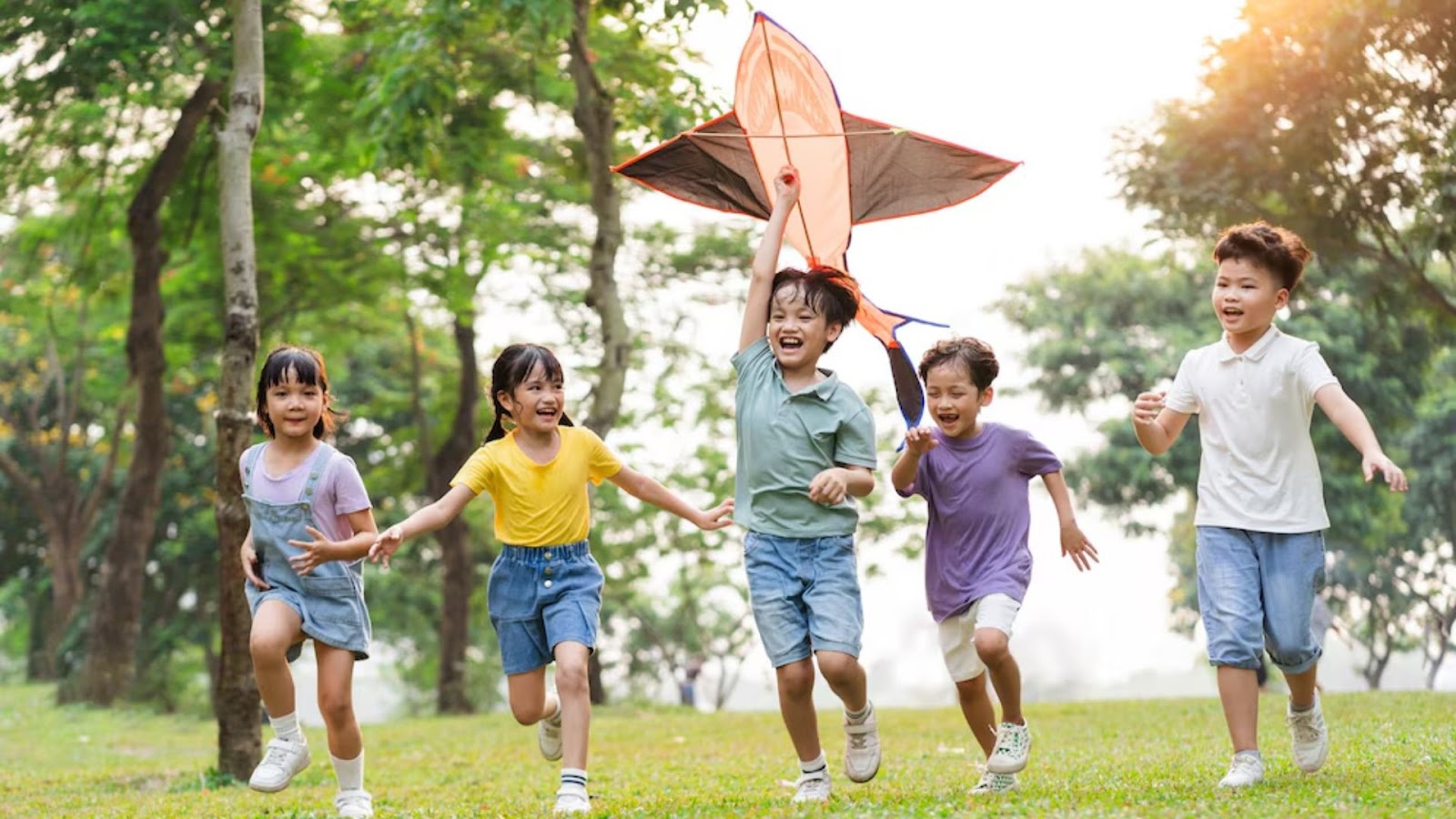 Active children running in a park – proper foot care supports movement and injury prevention in growing kids.
