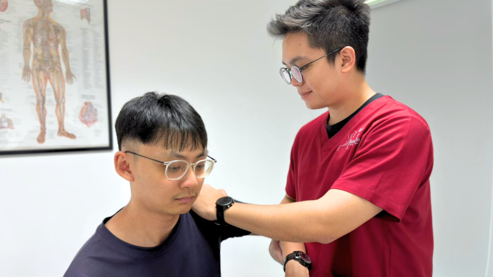 Physiotherapist performing a shoulder assessment under co-managed care with podiatry support