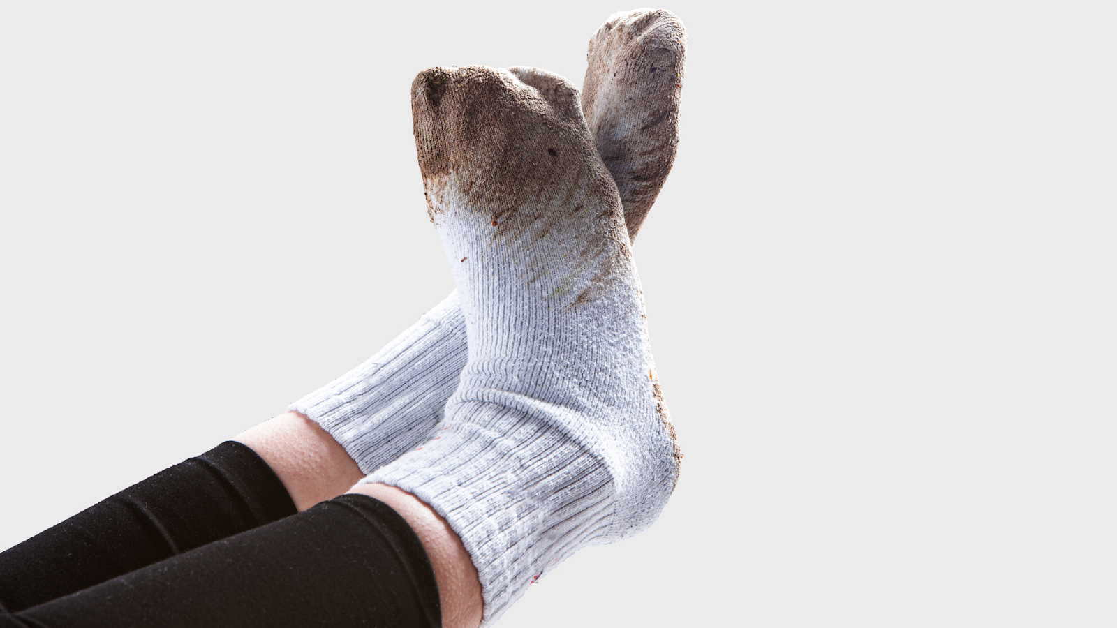 Cotton socks with dirt, illustrating hygiene issues contributing to foot skin peeling in children