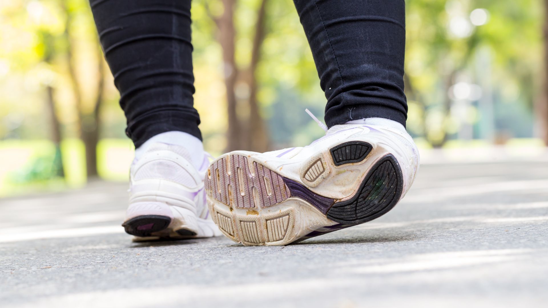 Person walking with ankle turning inward, a common mechanism for ankle sprains.