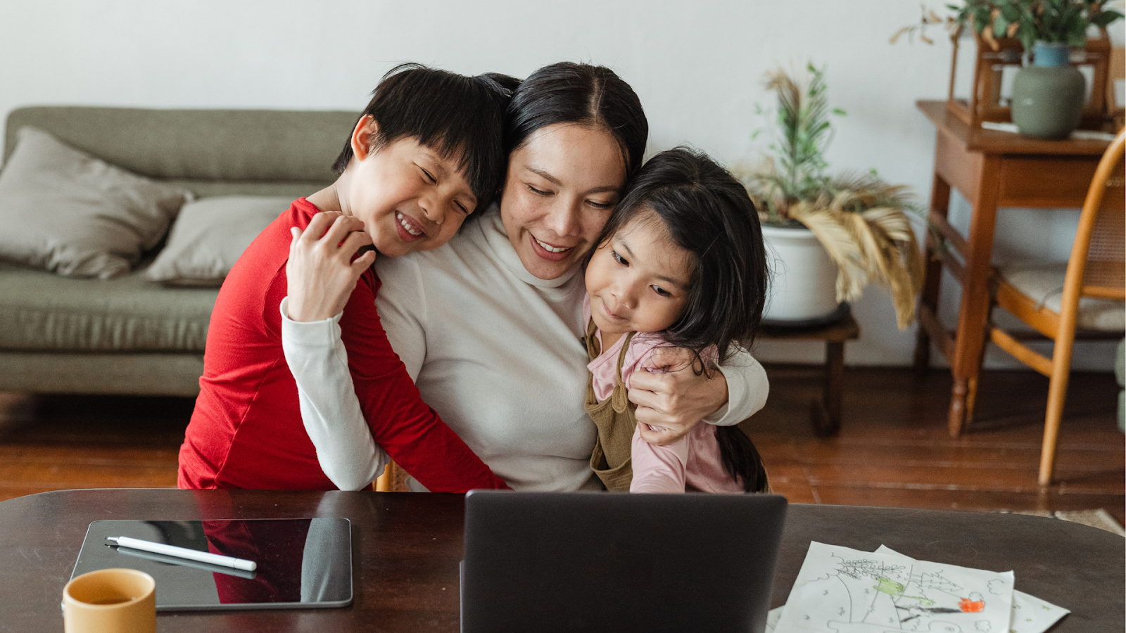 Mother embracing two kids at home – family support is key in managing Osgood-Schlatter’s Disease.