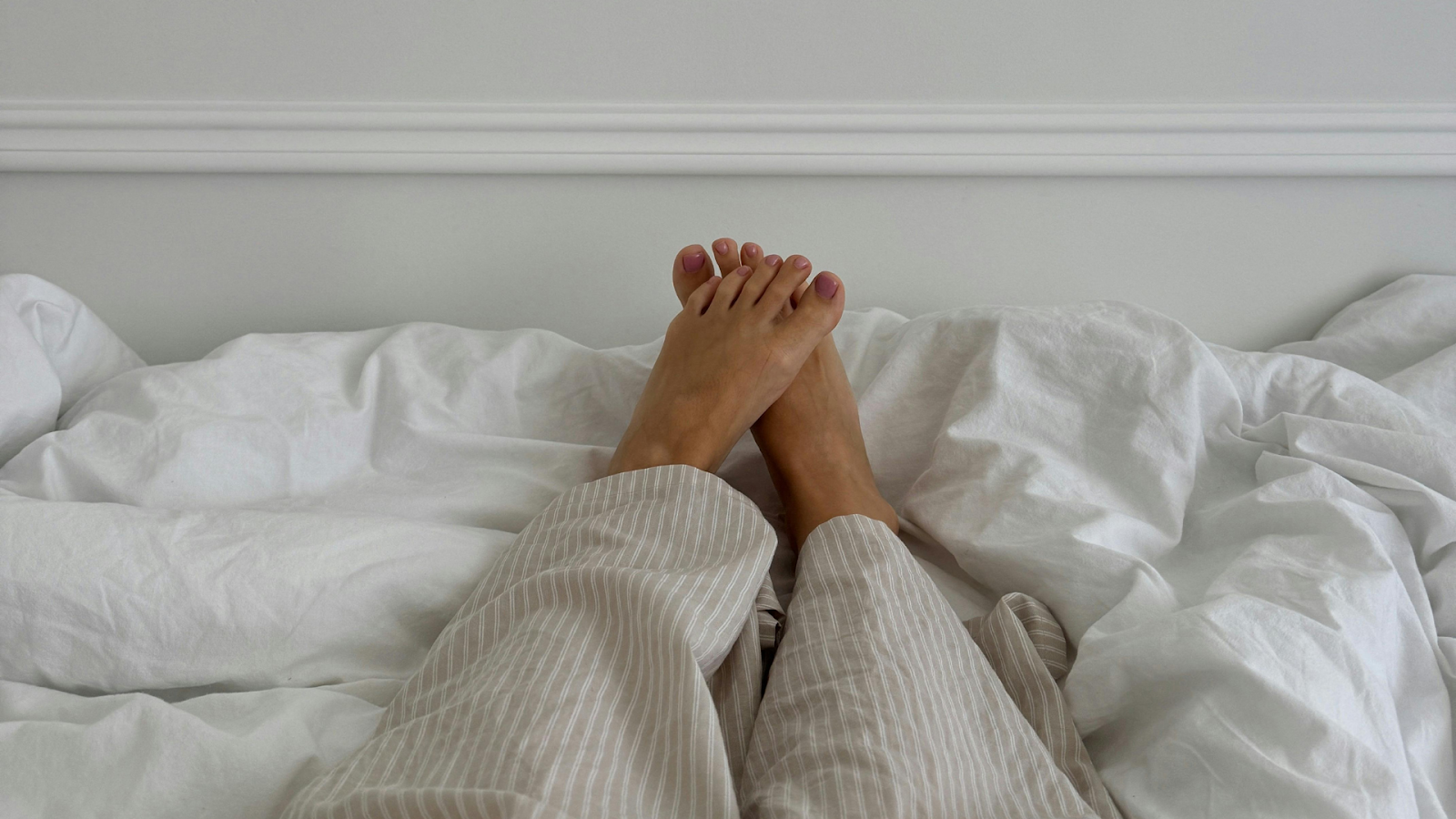 Resting legs on bed as part of essential recovery after a stress fracture.