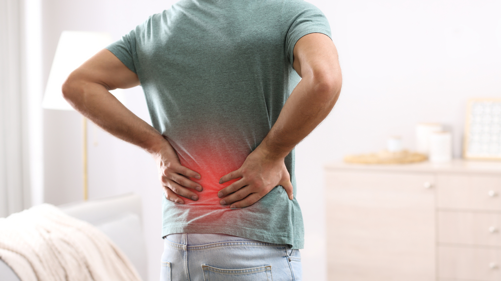 Person experiencing lower back pain possibly linked to poor posture from foot issues