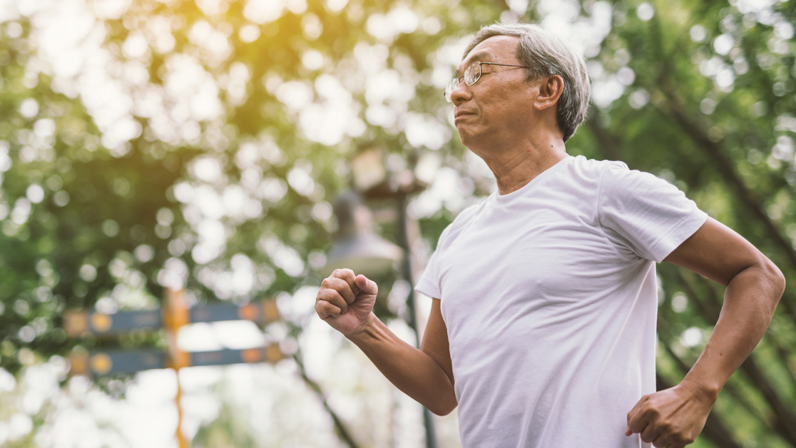 Senior man staying active with a brisk walk in the park to support bone health