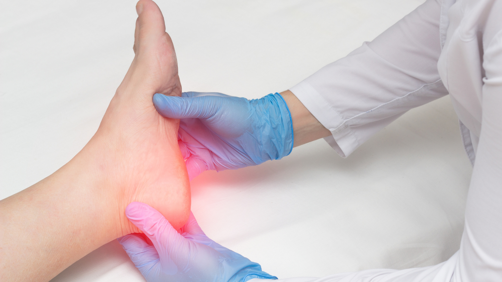 Physiotherapist assessing heel pain during plantar fasciitis treatment