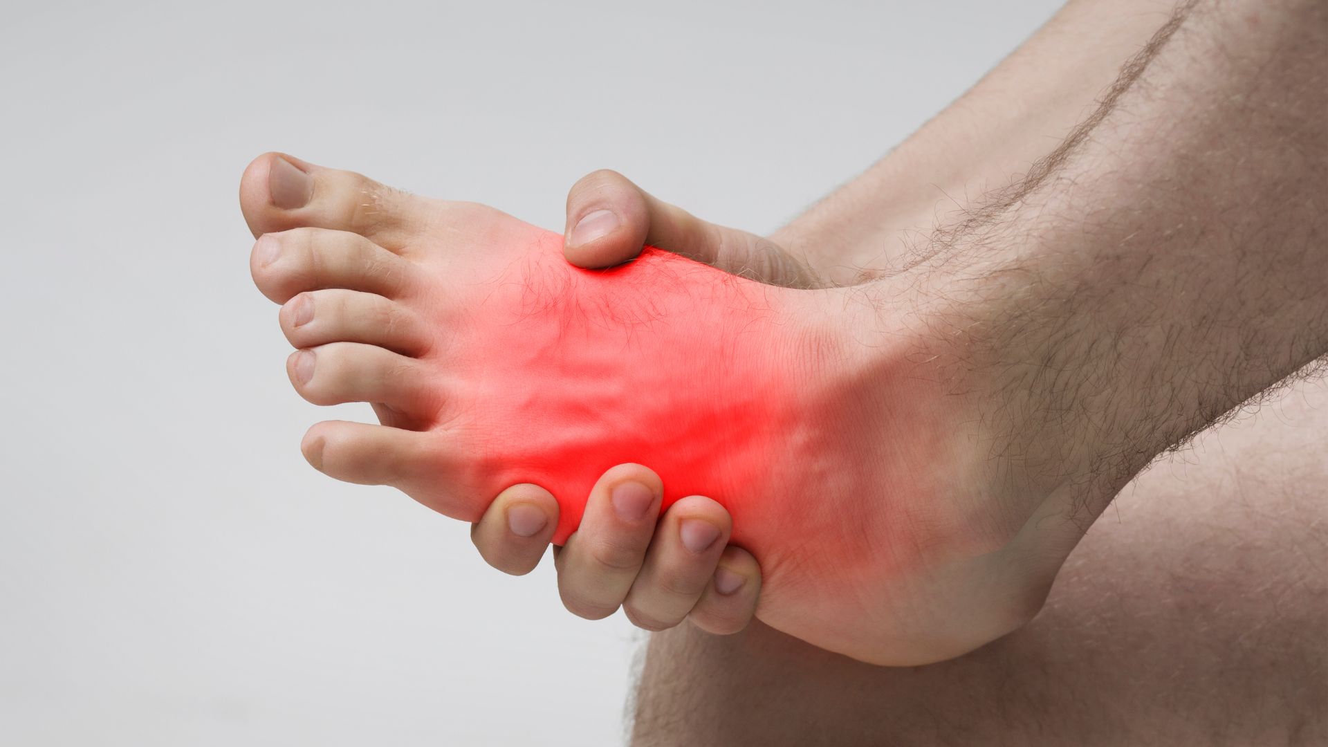 Close-up of intense midfoot pain, a common condition seen in Singapore.