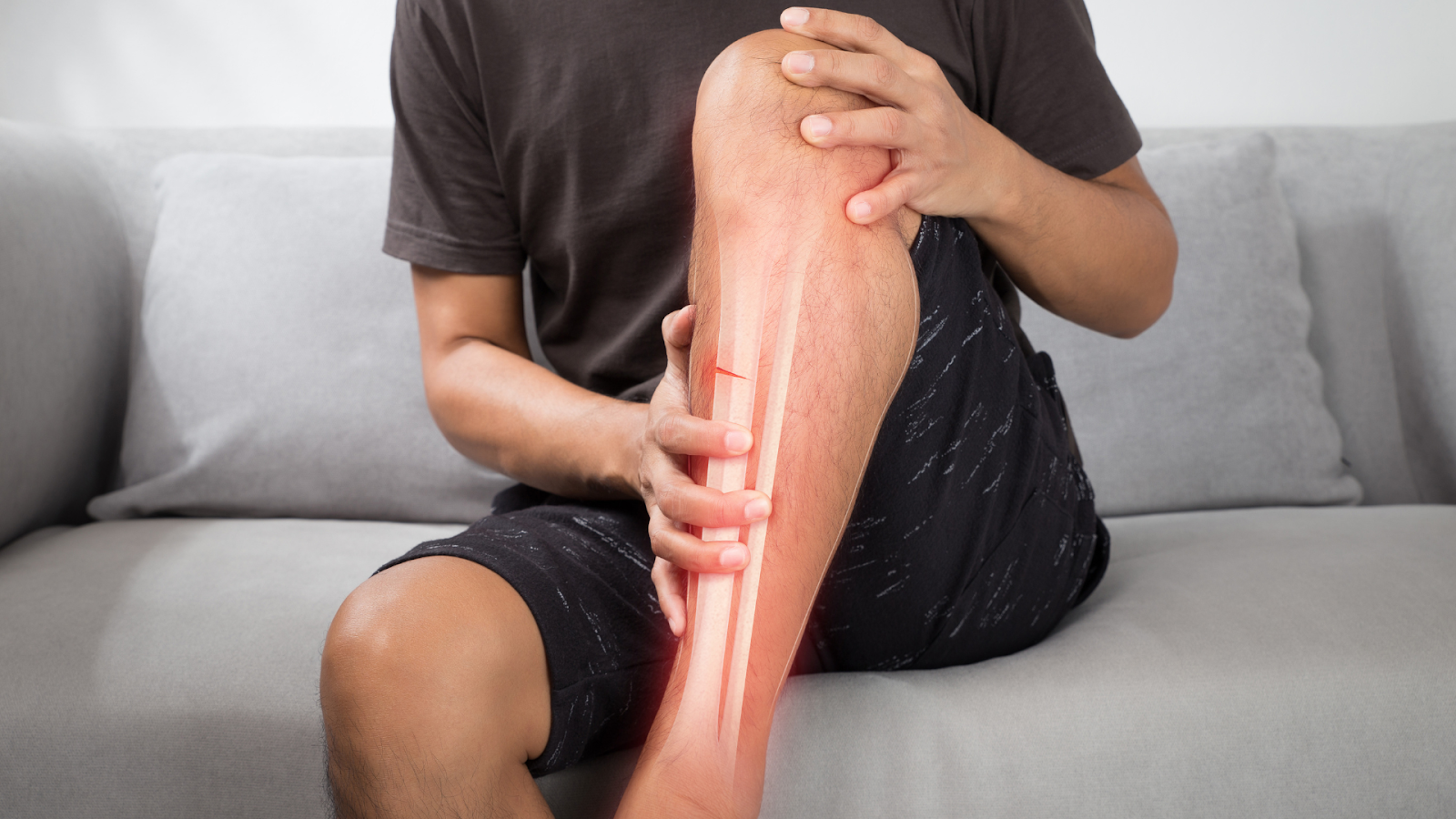 Man experiencing shin pain, a common cause of foot pain Singapore treated with physiotherapy.