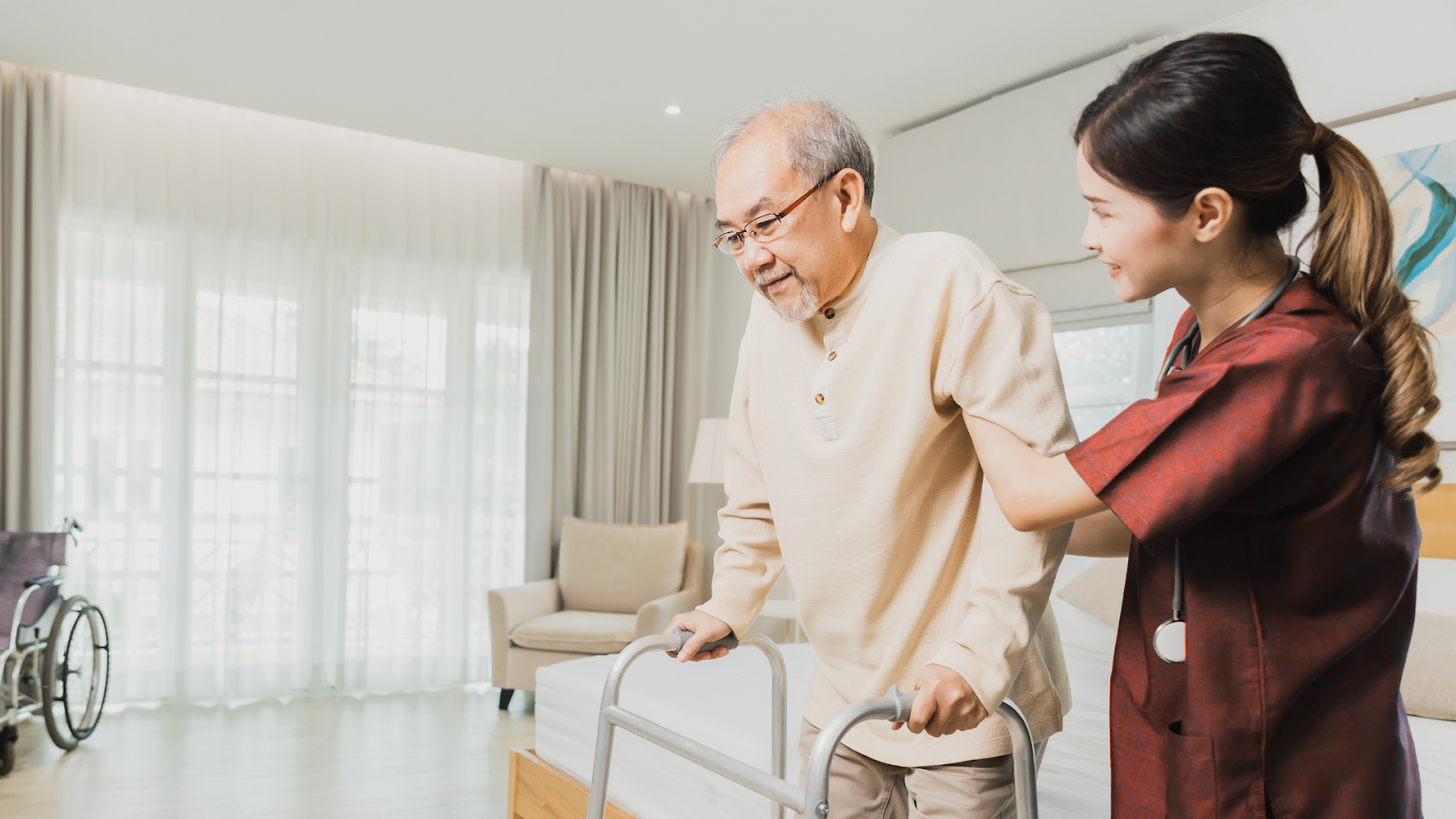 Senior man with rheumatoid arthritis receiving assistance from a physiotherapist at home in Singapore