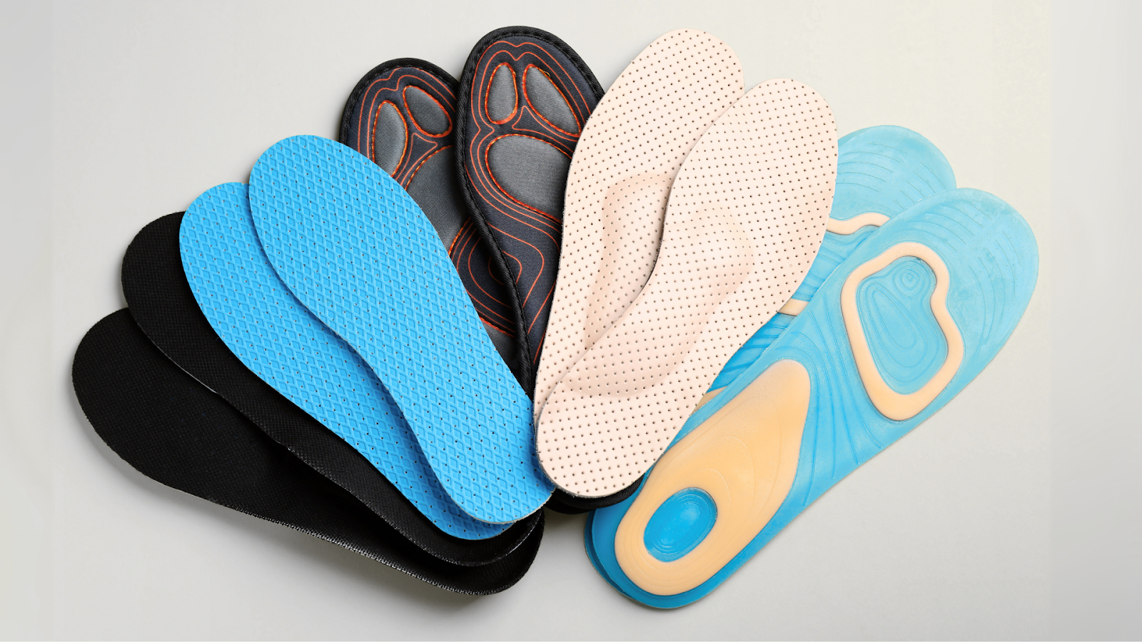 Different types of insoles laid out, showing materials and designs.