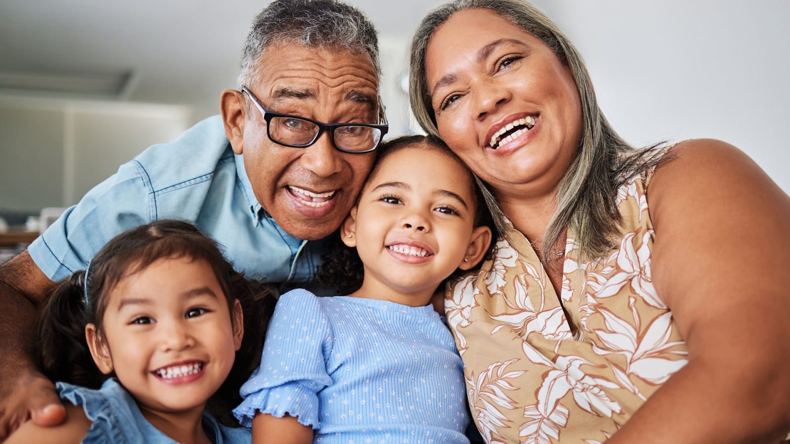Happy senior couple with grandchildren, managing rheumatoid arthritis and staying active