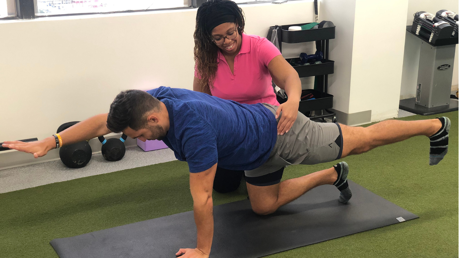 Physiotherapist guiding a patient through core strengthening exercises during rehab post-surgery.