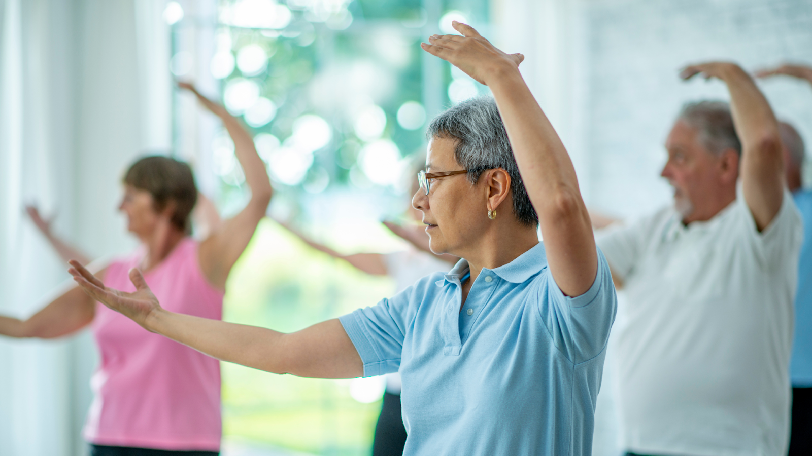 Elderly woman practicing tai chi to stay flexible and manage rheumatoid arthritis