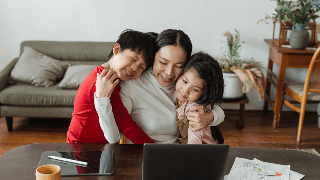 Mother hugging her two children at home, reassured after learning about pigeon toe treatment options