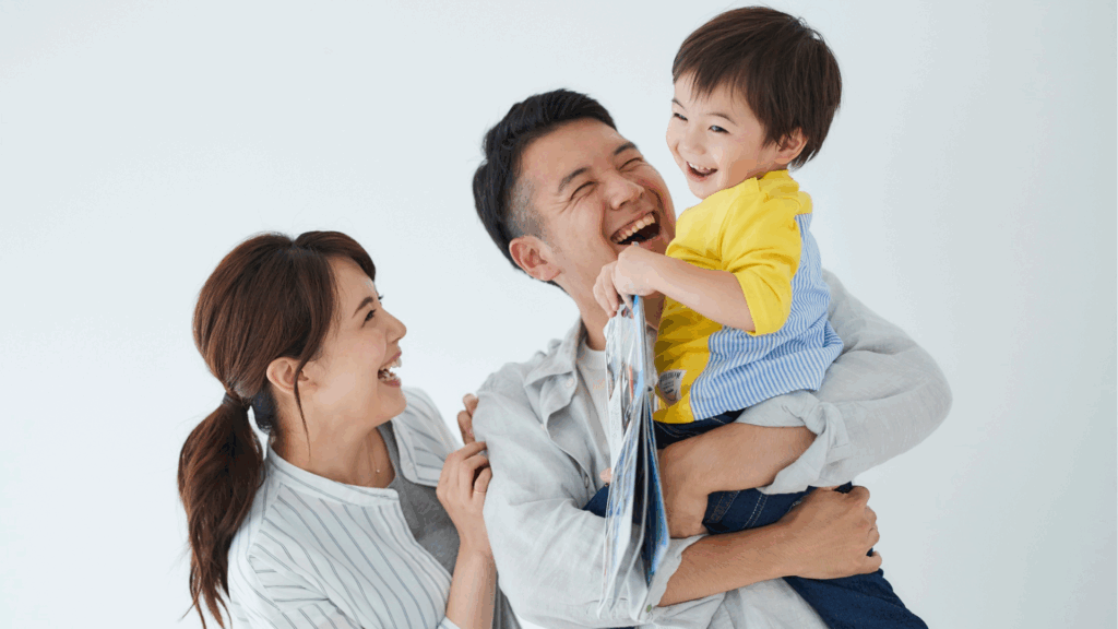 Parents carrying smiling child, reassured after pigeon toe check-up
