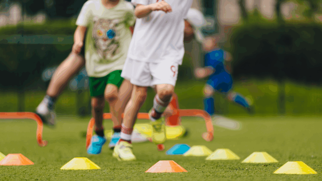 Child with pigeon toe running through agility cones during sports practice