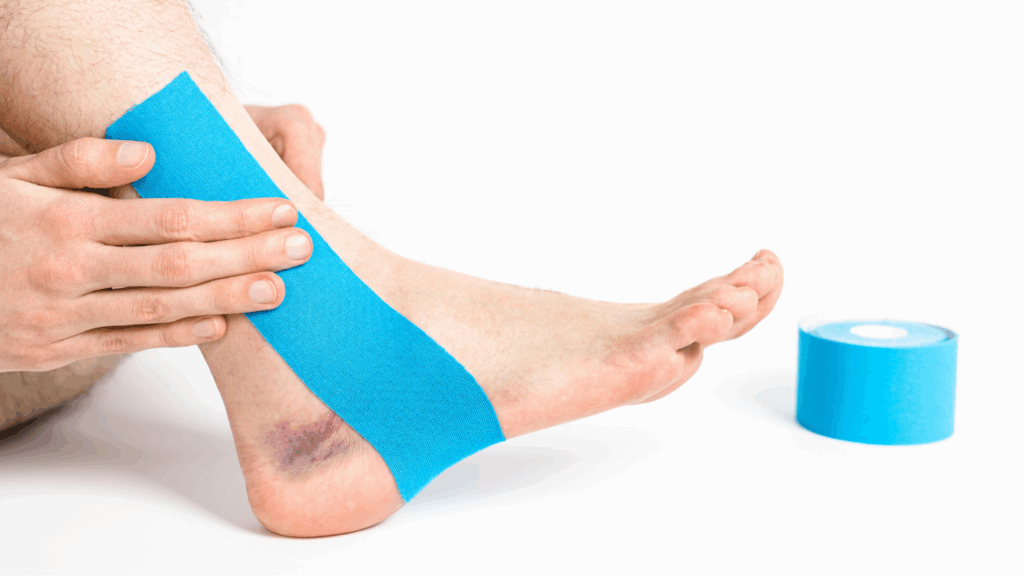 Ankle with blue kinesiology tape applied for support