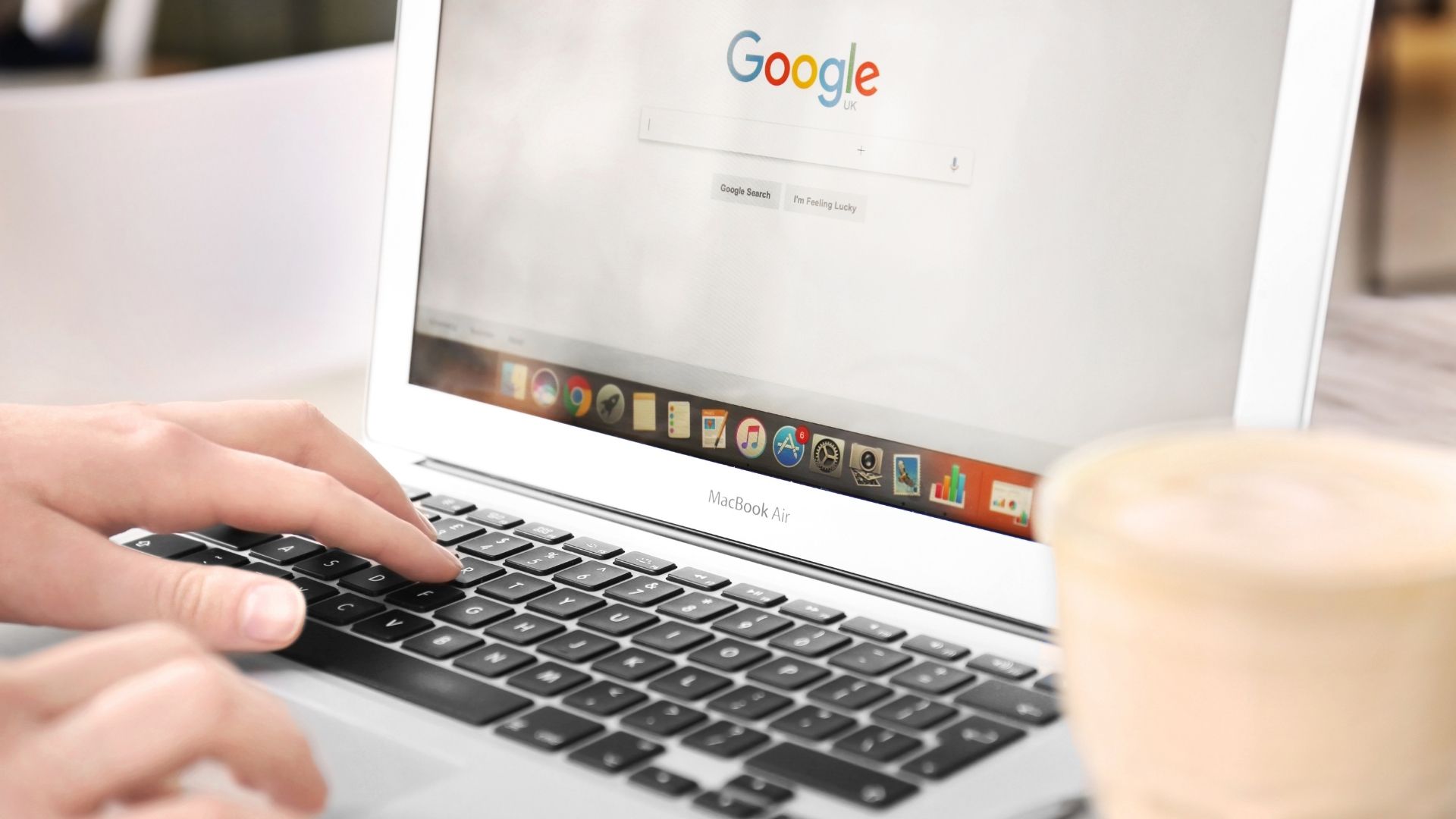 A person using a laptop to search online for podiatry clinic Singapore, researching qualified podiatrists and treatment options.