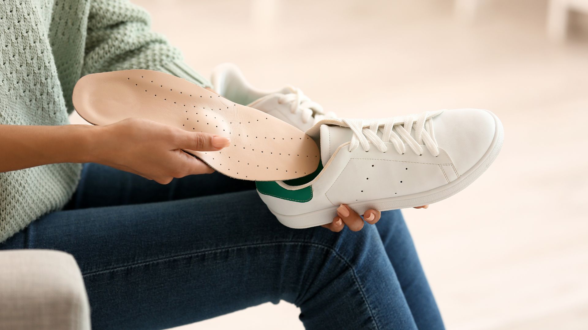 Podiatrist fitting custom orthotics for a patient to improve foot alignment and relieve pain in Singapore