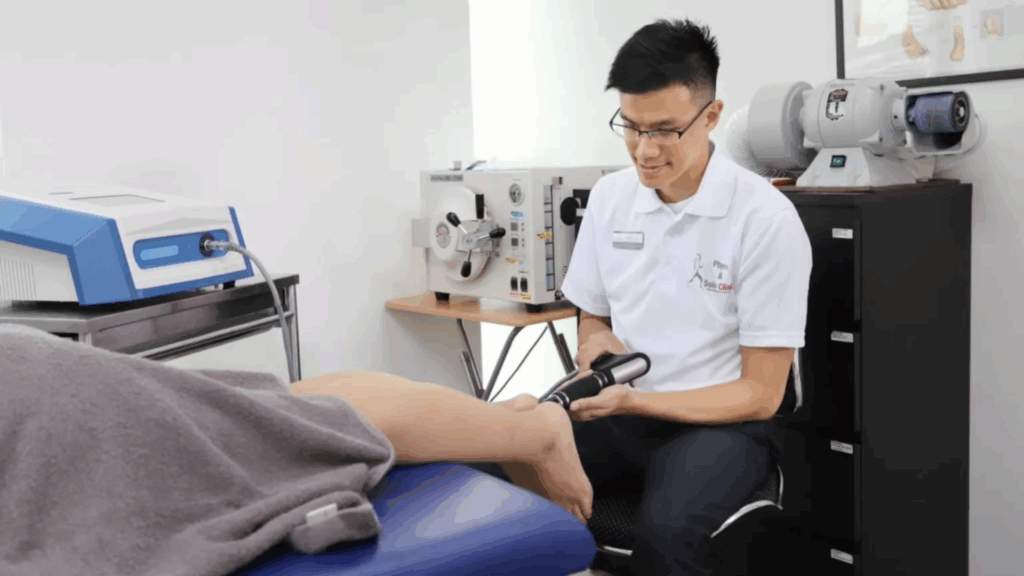 A podiatrist applying radial shockwave therapy on a patient’s foot to treat heel pain at Physio & Sole Clinic in Singapore.