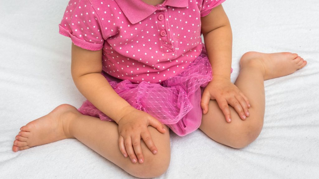Toddler sitting in a W-sitting position, a common posture physiotherapists monitor in early childhood development.