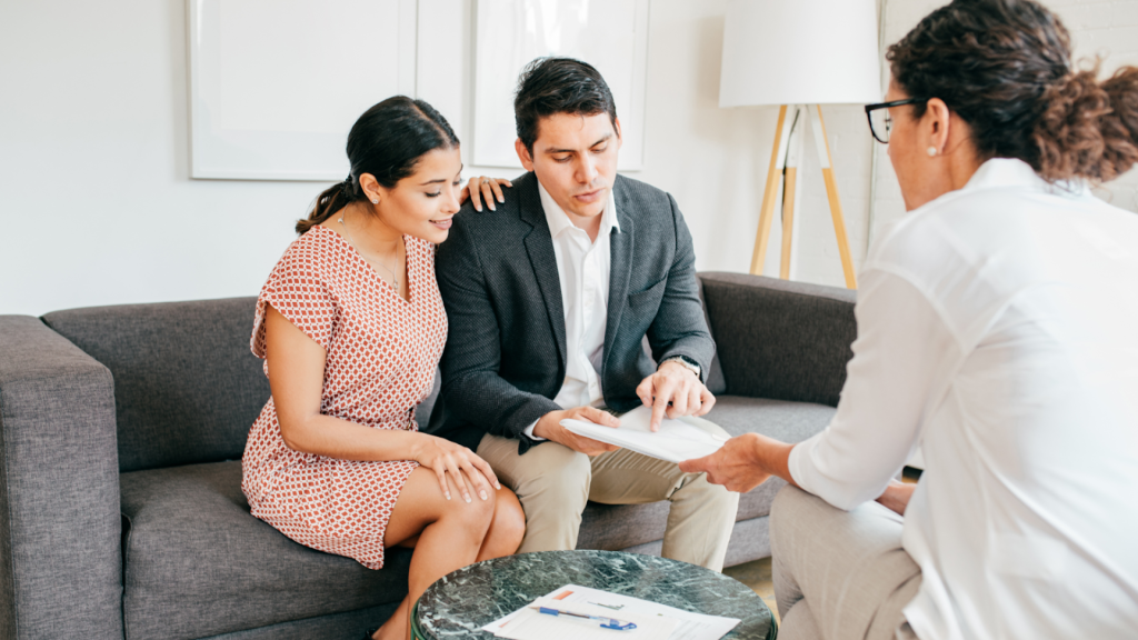 Parents reviewing information with a podiatrist during a consultation, discussing assessment findings and care options.