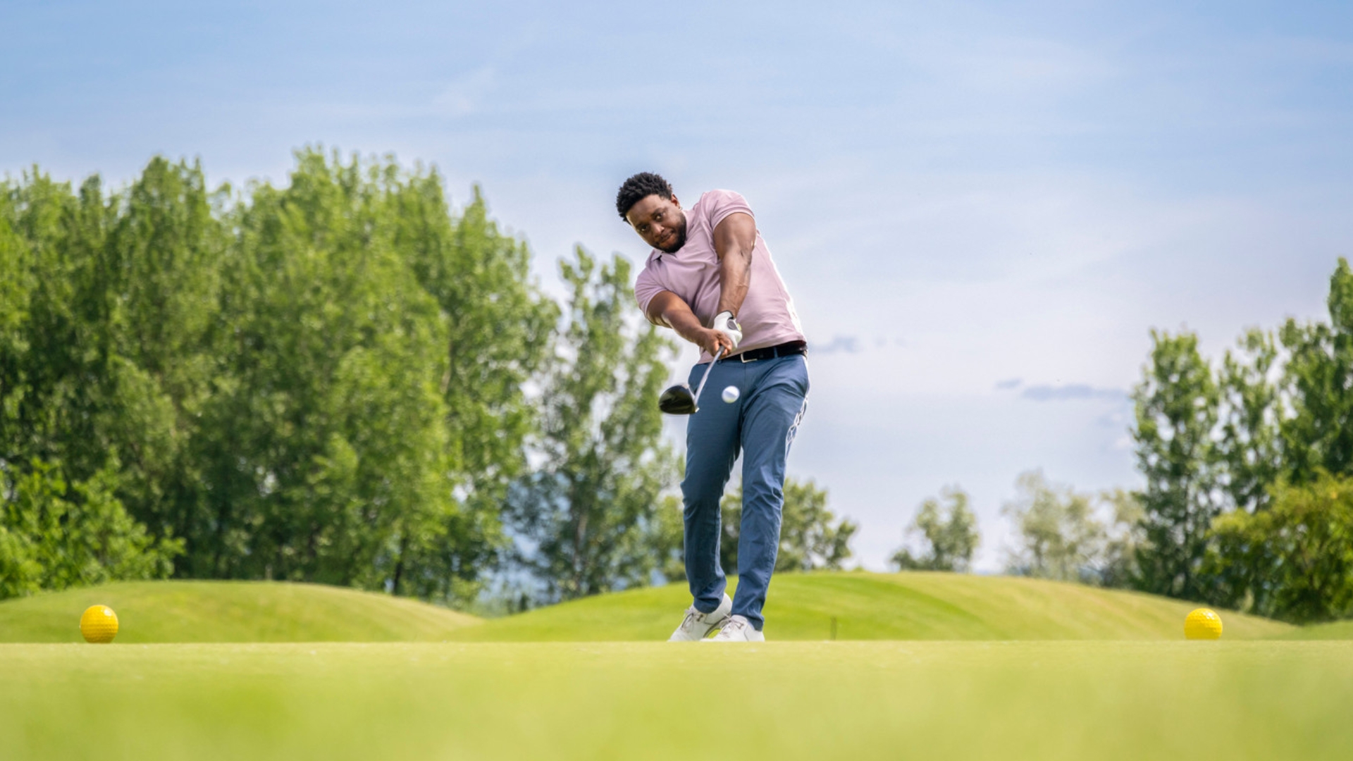 Golfer swinging a club during play, illustrating repetitive arm and elbow movement associated with golfer’s elbow.
